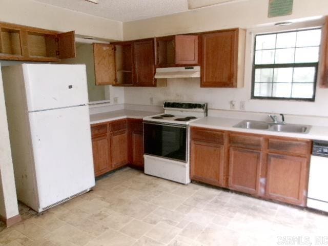 112 Huckleberry Ln, Monticello, AR 71655 - kitchen featuring white appliances, under cabinet range hood, a sink, and brown cabinetry