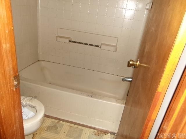 112 Huckleberry Ln, Monticello, AR 71655 - full bathroom featuring toilet, shower / bath combination, and tile patterned floors