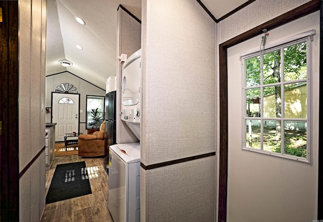 193 Sycamore, Sheridan, AR 72150 - laundry room featuring estacked washer and dryer, dark wood finished floors, healthy amount of natural light, and a textured ceiling