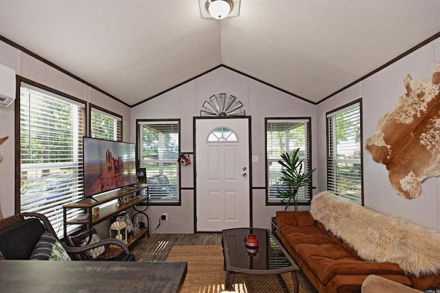 193 Sycamore, Sheridan, AR 72150 - living room featuring wood finished floors, vaulted ceiling, a textured ceiling, and ornamental molding