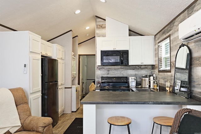193 Sycamore, Sheridan, AR 72150 - kitchen featuring black appliances, a peninsula, a sink, dark countertops, and lofted ceiling