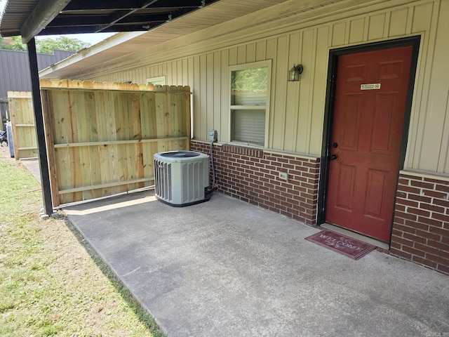 1615 Aldersgate Rd, Little Rock, AR 72205 - doorway to property with brick siding, cooling unit, and board and batten siding