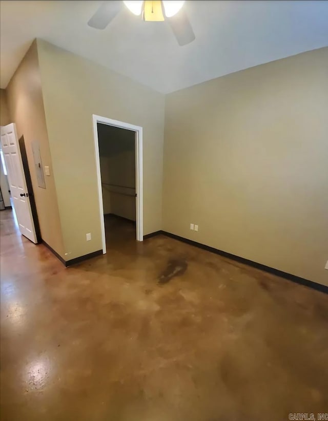 1615 Aldersgate Rd, Little Rock, AR 72205 - unfurnished bedroom featuring baseboards, finished concrete floors, a walk in closet, a closet, and a ceiling fan