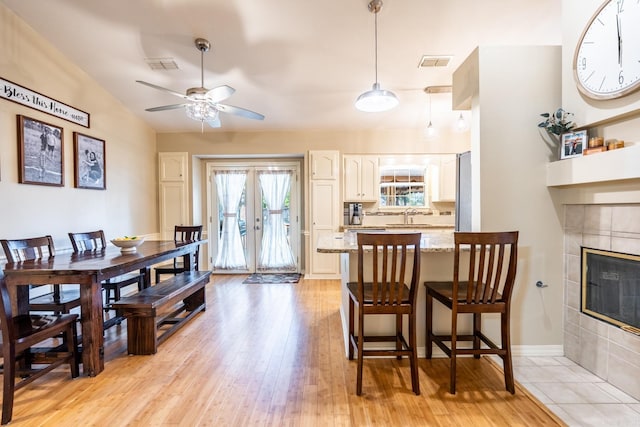 1715 Drury Ln, Conway, AR 72034 - dining space with a ceiling fan, light wood-style floors, a fireplace, and baseboards