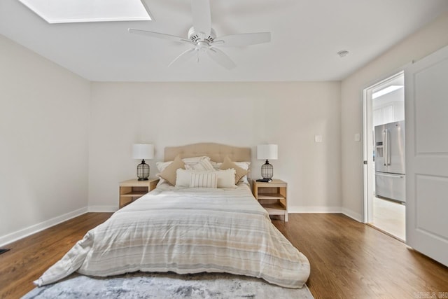 104 Dickson Dr, Little Rock, AR 72207 - bedroom with stainless steel fridge with ice dispenser, wood finished floors, baseboards, a ceiling fan, and a skylight