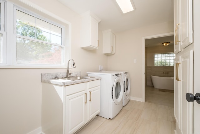 104 Dickson Dr, Little Rock, AR 72207 - laundry room featuring washing machine and dryer, cabinet space, and baseboards