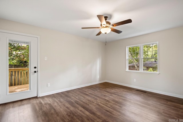 104 Dickson Dr, Little Rock, AR 72207 - unfurnished room featuring plenty of natural light, baseboards, dark wood-style floors, and a ceiling fan