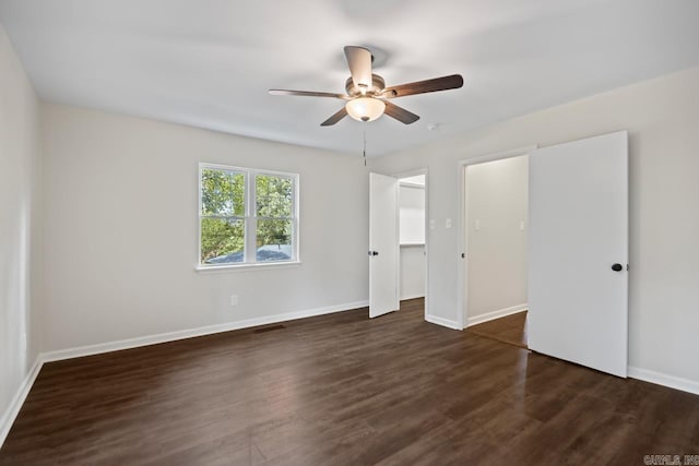104 Dickson Dr, Little Rock, AR 72207 - unfurnished bedroom featuring dark wood-style floors, baseboards, and a ceiling fan