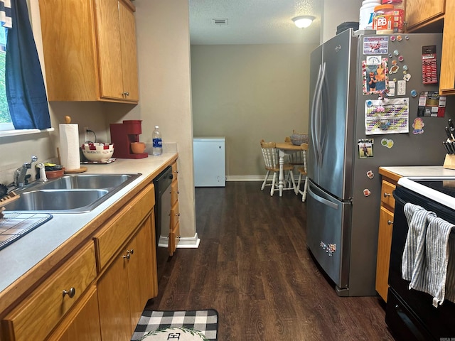 3537 W 26th Hwy, Arkadelphia, AR 71923 - kitchen with black appliances, dark wood-type flooring, a sink, light countertops, and brown cabinetry