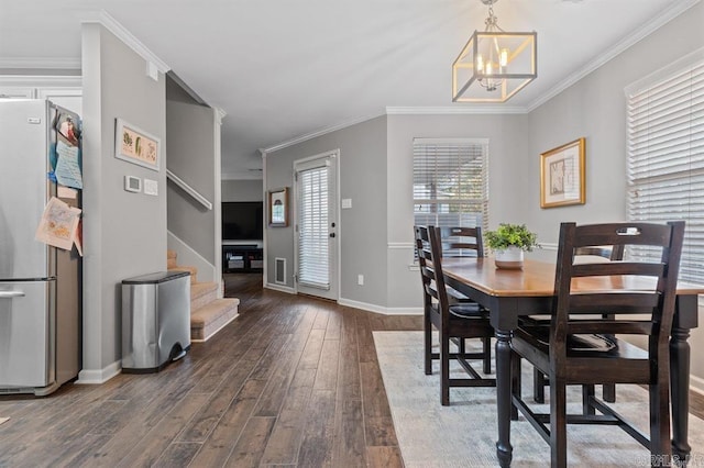 9 Westoak Cir, Little Rock, AR 72223 - dining area with hardwood / wood-style floors, a chandelier, stairway, ornamental molding, and baseboards