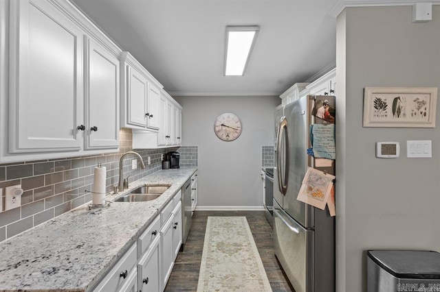 9 Westoak Cir, Little Rock, AR 72223 - kitchen featuring appliances with stainless steel finishes, a sink, decorative backsplash, white cabinetry, and dark wood-style floors