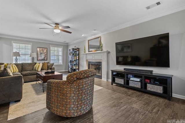 9 Westoak Cir, Little Rock, AR 72223 - living area with wood finished floors, a ceiling fan, crown molding, a tiled fireplace, and baseboards