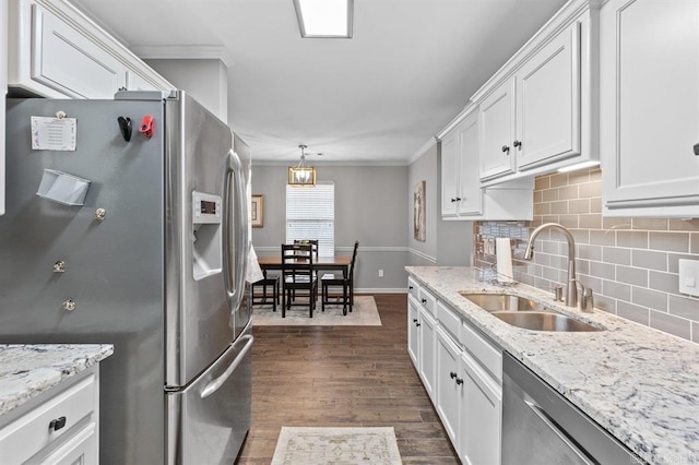 9 Westoak Cir, Little Rock, AR 72223 - kitchen with appliances with stainless steel finishes, a sink, backsplash, white cabinets, and dark wood-style floors