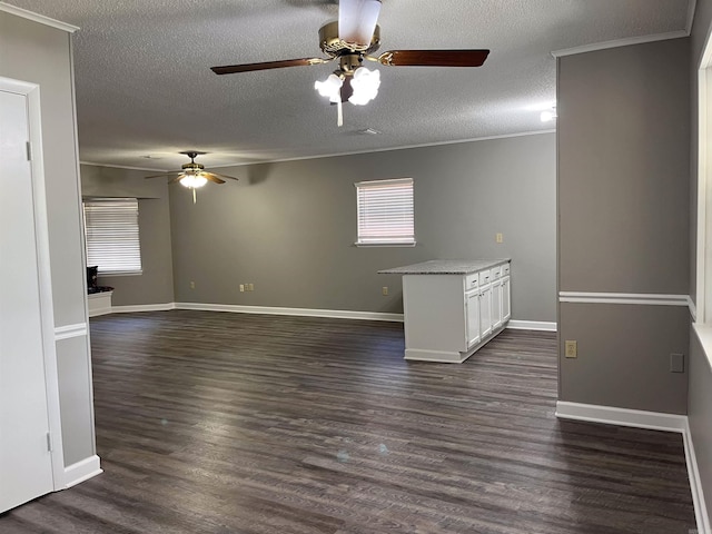 2411 Broadview Ave, Conway, AR 72034 - spare room featuring a ceiling fan, a textured ceiling, dark wood-style floors, crown molding, and baseboards