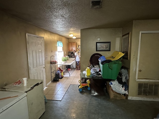 422 Mimosa Rd, North Little Rock, AR 72117 - kitchen featuring a textured ceiling and refrigerator