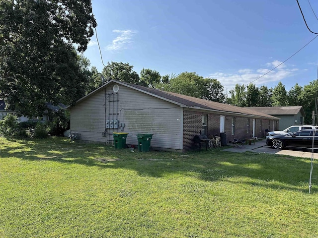 422 Mimosa Rd, North Little Rock, AR 72117 - view of property exterior featuring a lawn, brick siding, and a patio
