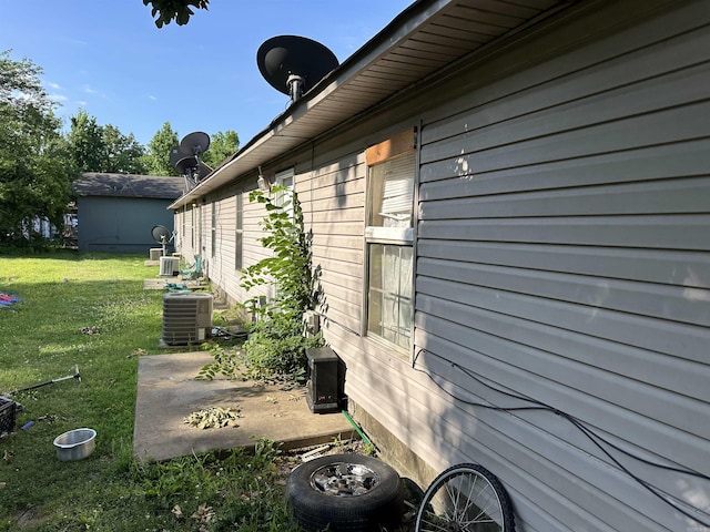 422 Mimosa Rd, North Little Rock, AR 72117 - view of property exterior with a lawn, a patio, and central AC unit