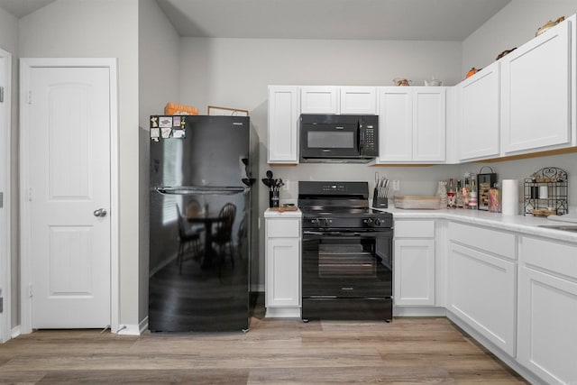 229 Baldwin Dr, Beebe, AR 72012 - kitchen featuring black appliances, white cabinetry, light countertops, and light wood-style floors