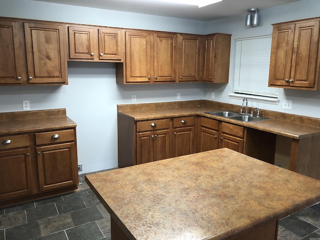 6 Bryan Keith Ct, Little Rock, AR 72206 - kitchen featuring a sink, dark stone finish floors, dark countertops, and a center island