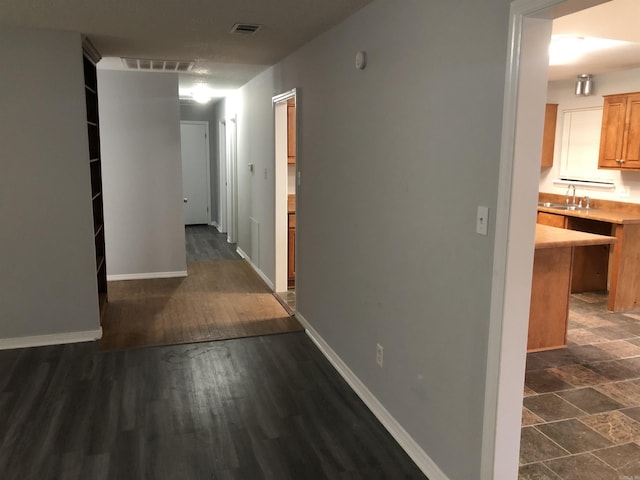 6 Bryan Keith Ct, Little Rock, AR 72206 - hallway featuring a sink, baseboards, and dark wood-style floors