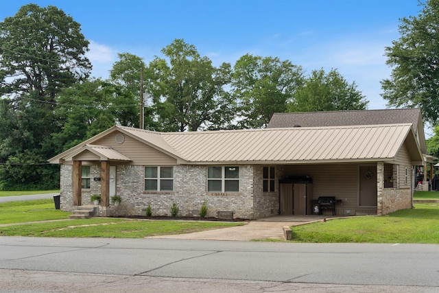 508 W Bell, Sheridan, AR 72150 - ranch-style home featuring brick siding, driveway, a front lawn, an attached carport, and metal roof