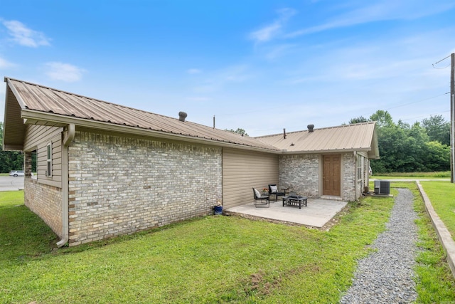 508 W Bell, Sheridan, AR 72150 - rear view of property featuring a patio, an outdoor fire pit, a lawn, metal roof, and cooling unit