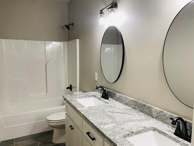 5104 Peace Ln, Alexander, AR 72002 - full bath with double vanity, toilet, shower / bath combination, and wood finished floors