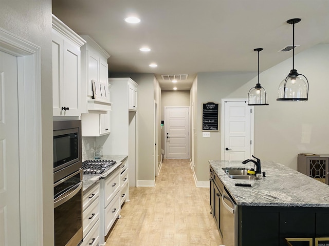 5104 Peace Ln, Alexander, AR 72002 - kitchen featuring a sink, stainless steel appliances, light wood-type flooring, white cabinetry, and light stone countertops