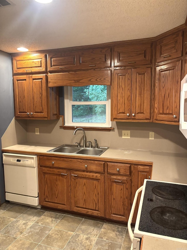 13 Page Cv, Maumelle, AR 72113 - kitchen featuring dishwasher, a sink, stove, a textured ceiling, and brown cabinets