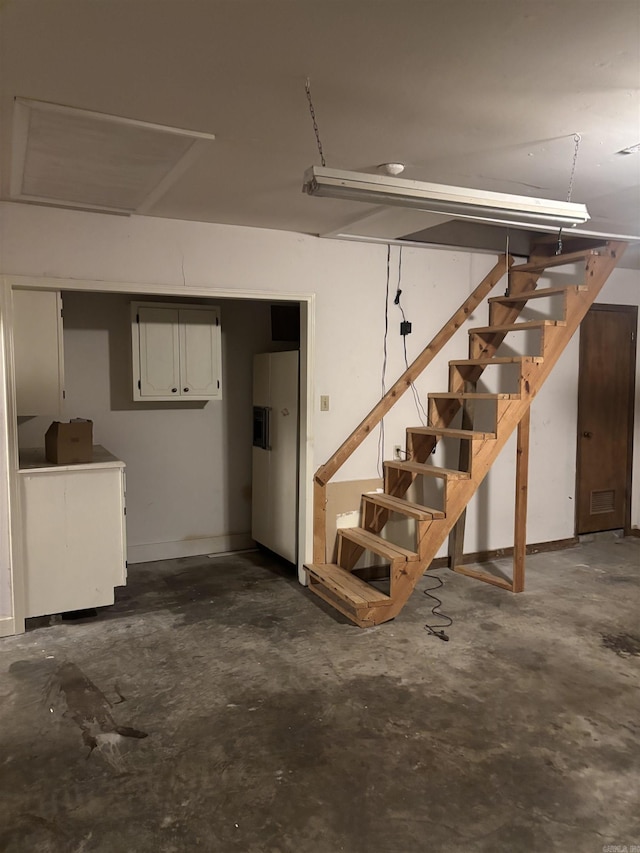 13 Page Cv, Maumelle, AR 72113 - garage with white refrigerator with ice dispenser and baseboards