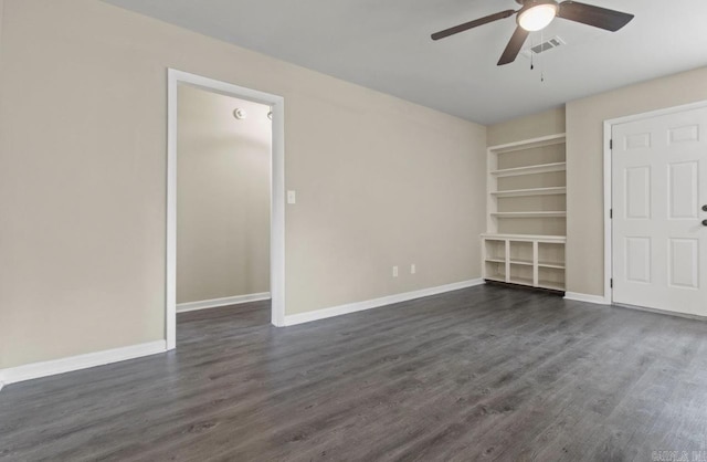 610 E 33rd Ave, Pine Bluff, AR 71601 - unfurnished living room featuring ceiling fan, dark wood-style flooring, baseboards, and built in shelves