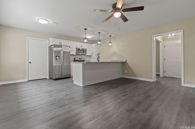 610 E 33rd Ave, Pine Bluff, AR 71601 - kitchen featuring stainless steel appliances, white cabinets, a peninsula, a ceiling fan, and dark wood-type flooring