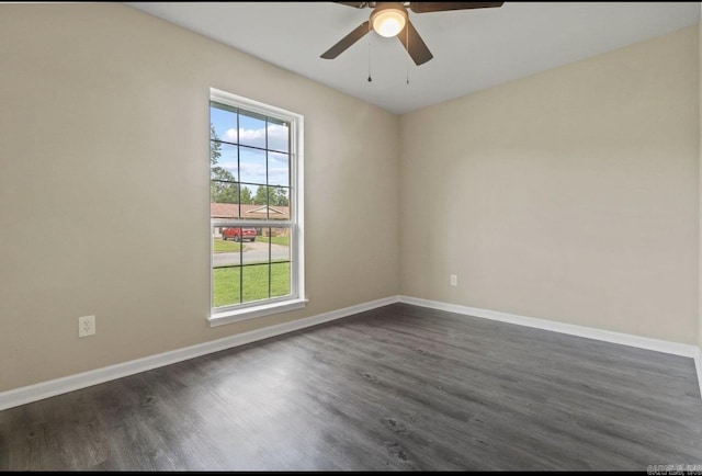 610 E 33rd Ave, Pine Bluff, AR 71601 - spare room featuring dark wood-style flooring, ceiling fan, and baseboards