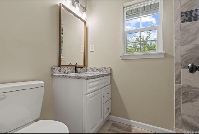 610 E 33rd Ave, Pine Bluff, AR 71601 - bathroom featuring vanity, toilet, baseboards, and a tile shower