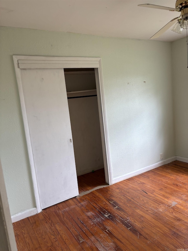211 Murray, Dierks, AR 71833 - unfurnished bedroom with wood finished floors, baseboards, a closet, and ceiling fan