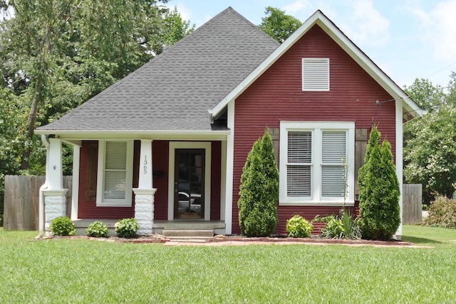 1365 Mitchell St, Conway, AR 72034 - view of front of property featuring a shingled roof, a front yard, and covered porch