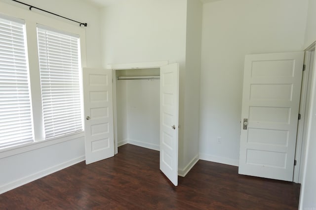 1365 Mitchell St, Conway, AR 72034 - unfurnished bedroom featuring dark wood-style flooring, a closet, and baseboards
