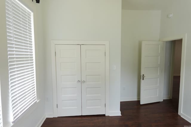 1365 Mitchell St, Conway, AR 72034 - unfurnished bedroom with dark wood-style flooring, a closet, and baseboards