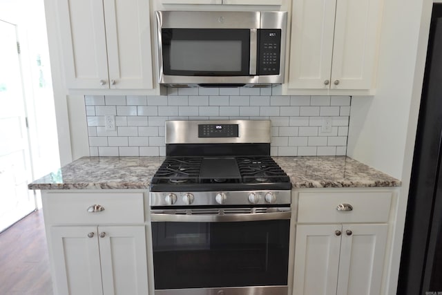 1365 Mitchell St, Conway, AR 72034 - kitchen with appliances with stainless steel finishes, tasteful backsplash, white cabinets, and light stone countertops
