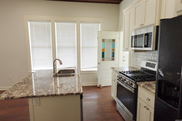 1365 Mitchell St, Conway, AR 72034 - kitchen featuring stainless steel appliances, a sink, light stone counters, dark wood-type flooring, and baseboards