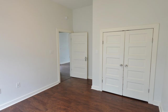 1365 Mitchell St, Conway, AR 72034 - unfurnished bedroom with dark wood-style floors, baseboards, and a closet
