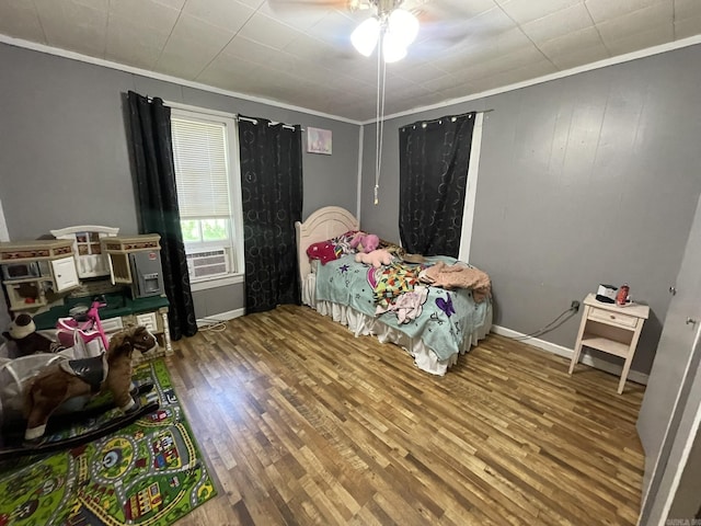 210 Gann St, Mena, AR 71953 - bedroom featuring crown molding, wood finished floors, baseboards, cooling unit, and a ceiling fan