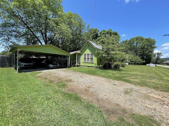 210 Gann St, Mena, AR 71953 - view of side of home with dirt driveway and a carport