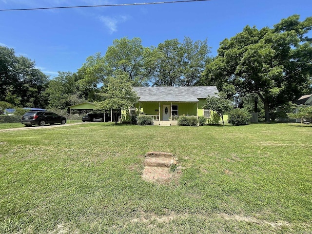 210 Gann St, Mena, AR 71953 - ranch-style home featuring a porch, a front lawn, and a carport
