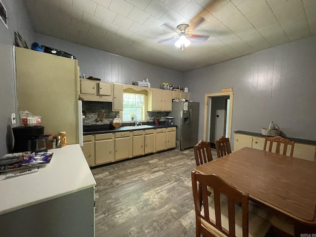 210 Gann St, Mena, AR 71953 - kitchen featuring stainless steel fridge with ice dispenser, a sink, a ceiling fan, light wood-style floors, and decorative backsplash