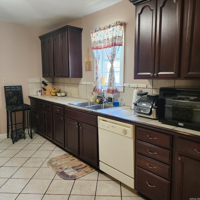 1401 S Schiller, Little Rock, AR 72202 - kitchen featuring white dishwasher, light tile patterned floors, a sink, and backsplash