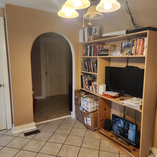 1401 S Schiller, Little Rock, AR 72202 - home office with arched walkways, light tile patterned flooring, built in shelves, and baseboards