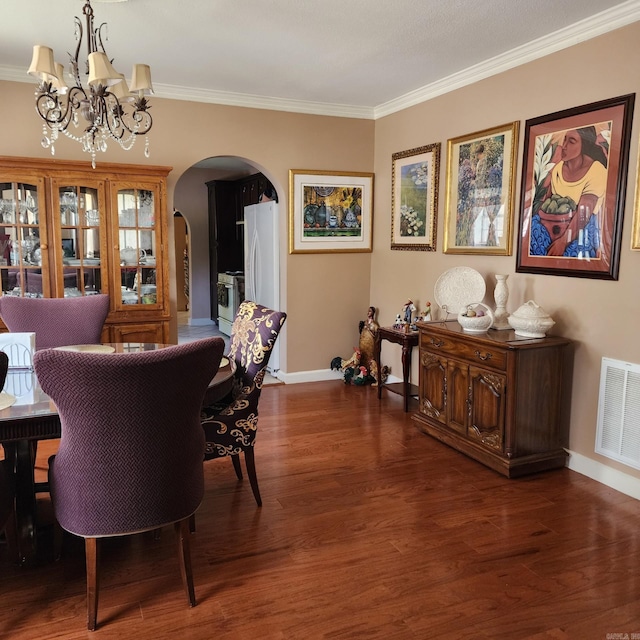 1401 S Schiller, Little Rock, AR 72202 - dining area with arched walkways, a chandelier, baseboards, wood finished floors, and ornamental molding