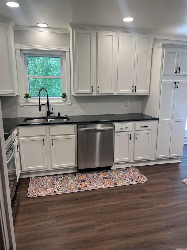 2715 Deer Xing, El Dorado, AR 71730 - kitchen with appliances with stainless steel finishes, a sink, dark wood finished floors, tasteful backsplash, and ornamental molding