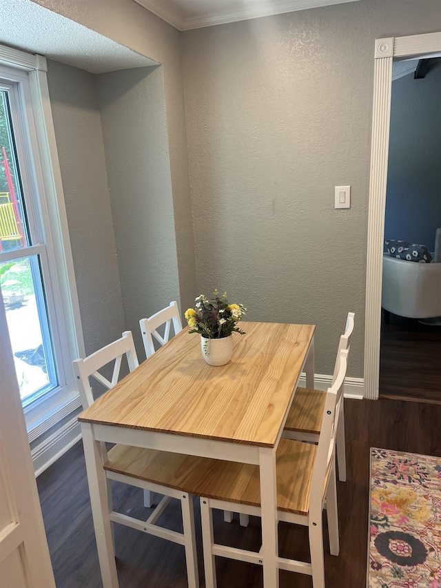 2715 Deer Xing, El Dorado, AR 71730 - dining space with dark wood-style flooring, baseboards, a textured wall, and crown molding